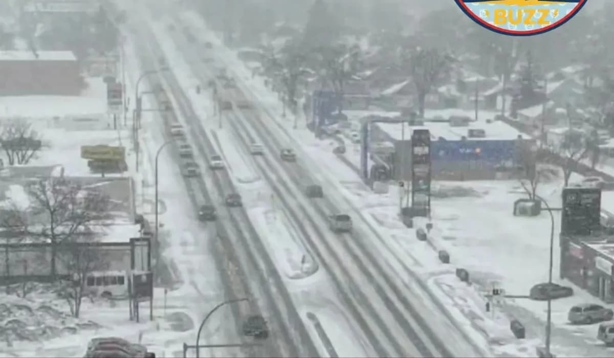Snow-covered road in Manitoba during spring storm warning with heavy snowfall and reduced visibility